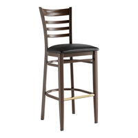 Lancaster Table & Seating Spartan Series Metal Ladder Back Bar Stool with Dark Walnut Wood Grain Finish and Black Vinyl Seat - Assembled