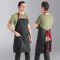 Uncommon Chef 3104 Black Customizable Poly-Cotton Rebel Bib Apron with Red Webbing and 3 Pockets - 34" x 36"