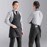 Uncommon Chef 3041 Black Customizable Poly-Cotton Twill V-Neck Tuxedo Apron with Adjustable Neck Strap and 2 Pockets - 28" x 24 1/2"