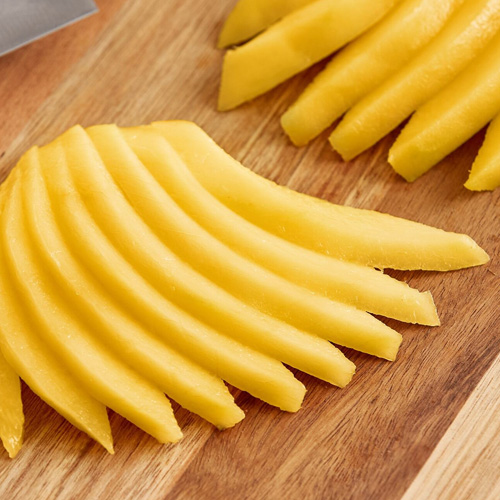 Sliced mangos on a cutting board