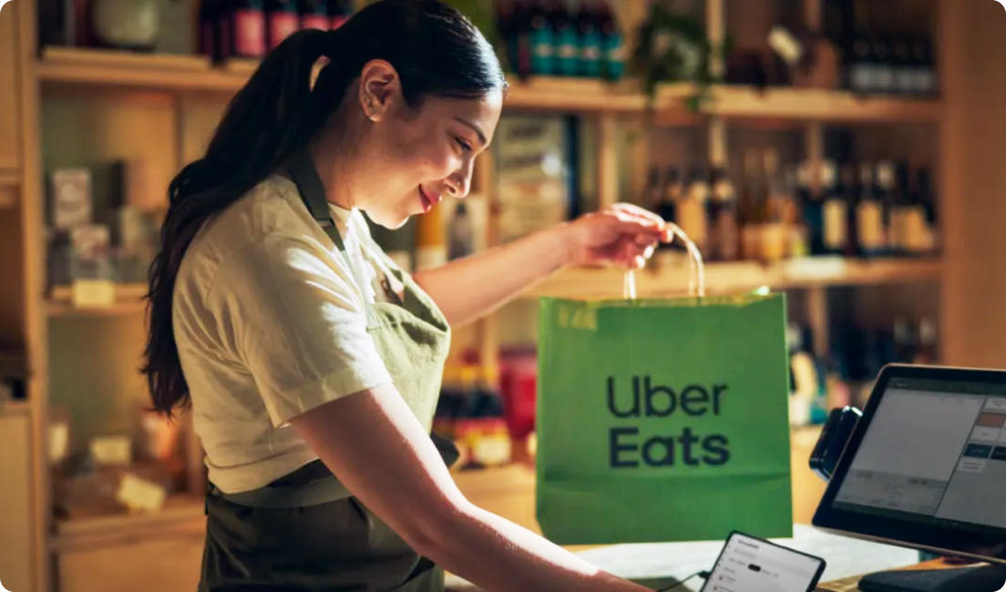 restaurant worker holder Uber Eats paper bag